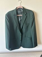 Front view of the dark green Joseph & Feiss suit jacket showing lapels, front pockets, and buttons.