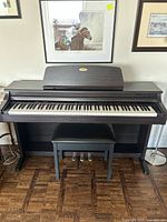 Front view of digital piano with closed key cover and bench in front
