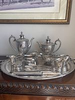 Full view of entire silver tea and service set displayed on tray