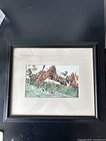 Full view of the framed watercolour painting illustrating a hunter race scene with horses and riders jumping over water.