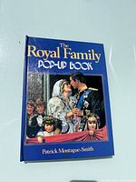 Front cover of the pop-up book showing title, author, and a royal wedding scene pop-up illustration.