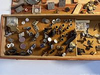 Drawer tray with assorted metal cufflinks and accessory parts