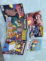 Top view of all comics and magazines included in the lot laid out flat, showing colorful covers and titles.