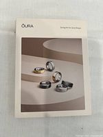 Front of the Oura Ring 4 Sizing Kit box showing an image of multiple ring pieces in different colors and sizes on a neutral background.