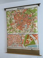 Full view of vintage retractable classroom wall map of Moscow with visible mounting bars on top and bottom.