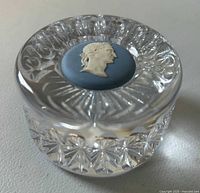 Crystal cut paperweight showing the integrity and design of Wedgwood jasperware medallion top with classical figure profile in white relief on blue base.