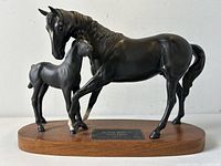 Front angle showing Black Beauty horse and foal together on wood plinth with plaque.