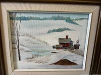 Full view of 'La Ferme Rouge' oil painting showing red farmhouse in a snow-covered Quebec winterscape, framed.
