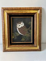 Front view of gilt-framed owl painting