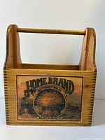 Rectangular wooden crate with arm handle and vintage Home Brand Butternut Bread label