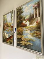 Two large framed paintings hung side by side on a wall, showing full works and frames.