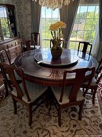 Overall view of round table set with ten chairs and lazy Susan