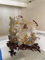 Full front view of sculpture on glass shelf