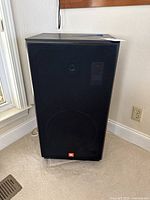 Front view of JBL CF120 speaker with grille on