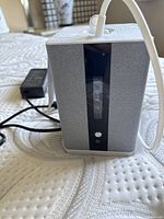 Front view of main unit with black LED control panel and attached white silicone tube