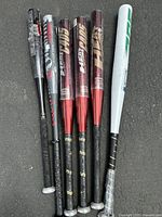 Six aluminum bats group shot showing various brands and colors including the Dudley Heat Series bats and others