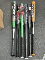 Top view of six aluminum baseball bats showing handles and barrels lined up.