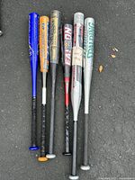 View of all six aluminum bats showing full length and colors, brands visible