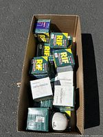 Box filled with approximately 12 RIF brand softball boxes and one unboxed white softball.