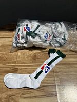 Single white knee-high sock with a green vertical stripe and a Hoffenholn logo showing clearly on the ankle area.