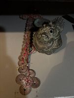 Pixiu figurine, coin sword and medallions arranged together