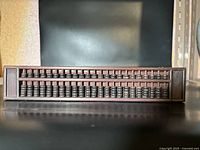 Front view of Chinese rosewood abacus showing horizontal rows of dark wooden beads and frame structure