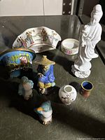 Overview of all Chinese collectibles including figurines and small pottery pieces.