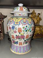 Front view of the large jar showing colorful floral and double happiness symbols on a white background.