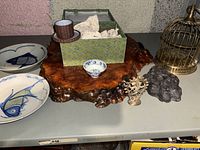Photo showing entire assortment including plates, teacup box, wooden base, birdcage and decorative items.