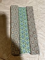 Three decorative fabric boxes containing the chopstick sets, showing the variety patterns of the boxes.