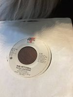Close-up image of the 45 RPM vinyl record label showing the artist name Kim Mitchell and song title Patio Lanterns.