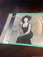 Glossy record sleeve featuring artist Whitney Houston with song title "Didn't We Almost Have It All."