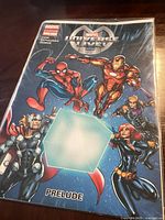 Front cover of Marvel Universe Live comic book showing main Marvel superheroes and title Prelude.