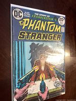 Photo of The Phantom Stranger comic book issue #27 cover showing main artwork and title