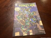 Front cover of Teenage Mutant Ninja Turtles Comic #1 showing the four turtles in action on a rooftop at night