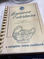 Cover of the 1984 Louisiana Entertains official cookbook showing spiral binding and decorative duck illustration.