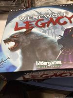 Photo of the game box cover showing "Ultimate Werewolf Legacy" title and werewolf art