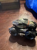 Side angle view of the black Rottweiler dog monster truck toy showing the detailed paint and large tires.
