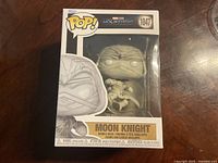 Front-facing image of boxed Moon Knight Funko Pop! vinyl figure, model 1047, with visible character illustration and product branding.