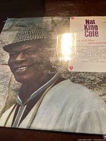 Front cover of Nat King Cole vinyl record album featuring a colored photograph of Nat King Cole.