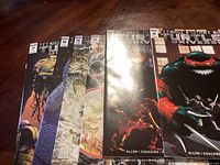 Photo showing six Teenage Mutant Ninja Turtles comic books, issues #1, 2, 4, 5, 6, and 7 from IDW Publishing with colorful covers featuring characters from the series.