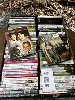 Overhead photo of DVD lot showing front stacks with titles visible including Kings of Comedy, Weeds, and others.
