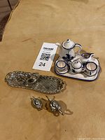 Photo showing the entire set: blue and white miniature ceramic coffee/tea set on a tray, small salt and pepper shakers, silver zinc serving tray