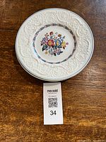 Stack of six Wedgwood salad plates with Morning Glory floral pattern and embossed rims on wood surface.