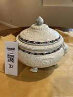 Side view of Wedgwood Morning Glory terrine with lid showing floral relief and painted band.