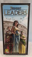 Front view of the sealed 7 Wonders Leaders expansion box featuring illustrated characters