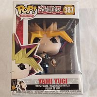 Front view of the boxed Funko Pop Animation Yami Yugi vinyl figure number 387 with clear display window showing the figure inside.
