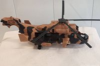 Side view of the GI Joe Tomahawk helicopter showing camo paint and rotor blades