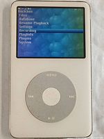 Front view of Apple iPod showing screen with Rockbox menu and circular click wheel controls.