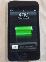Front screen of iPod Touch 2nd gen displaying lock screen with slide to unlock and battery indicator.